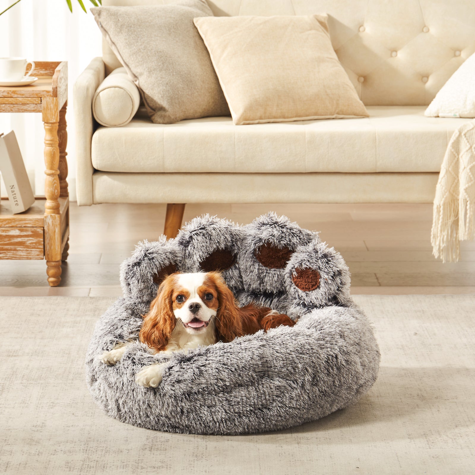 Charles spaniel dog resting in Inspaws gradient grey frost plush faux fur calming paw dog bed on living room floor