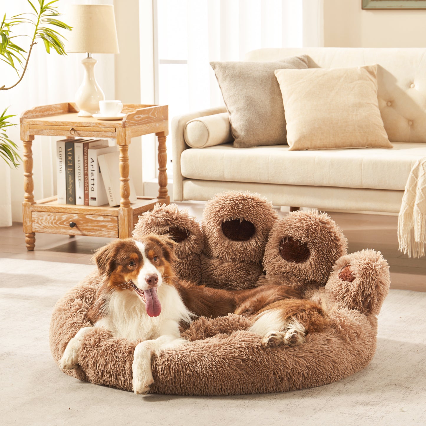 Border collie dog resting in Inspaws brown plush faux fur calming paw dog bed on living room floor