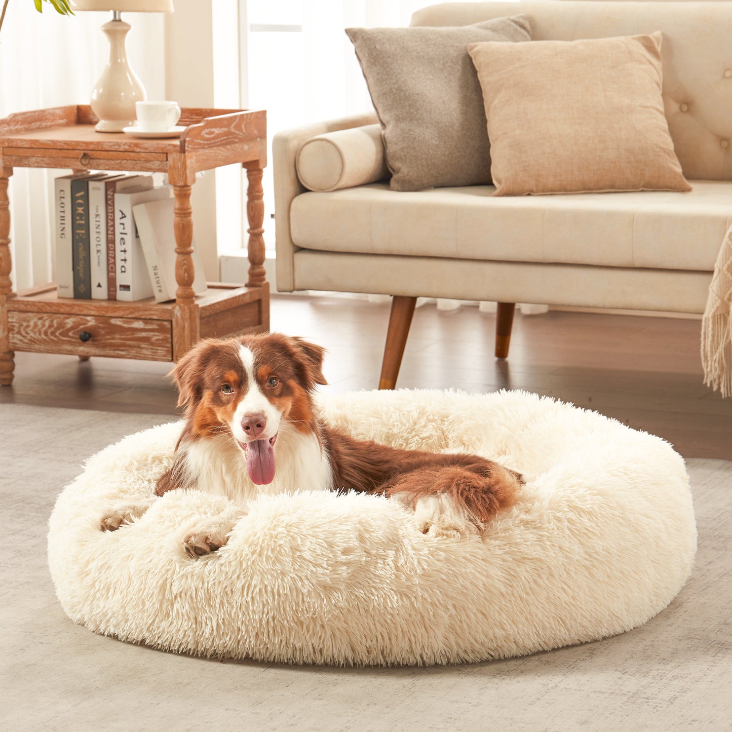 Dog resting in Inspaws calming donut dog bed in white plush faux fur