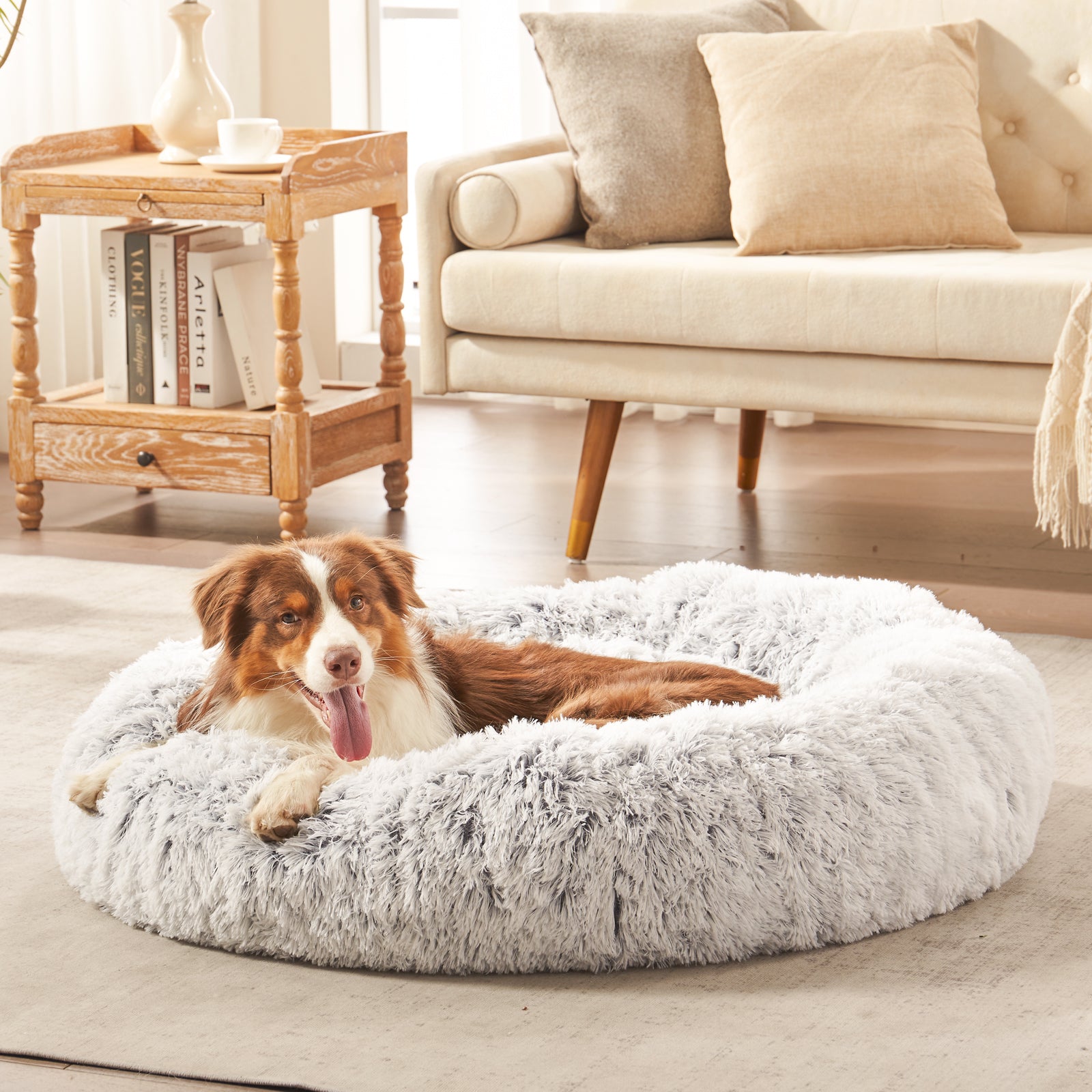 Dog resting in Inspaws calming donut dog bed in light grey frost plush faux fur