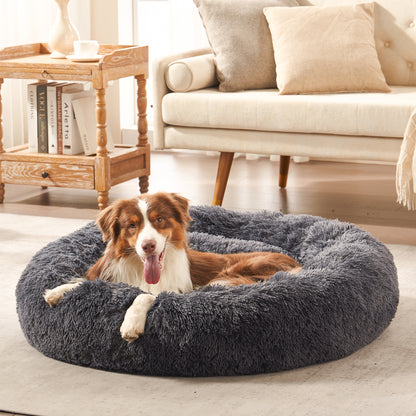 Dog resting in Inspaws calming donut cuddler dog bed in Dark Grey Shag Fur