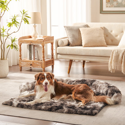 Dog lying on inspaws faux long fur bolster couch cover in ink tie-dye on floor in living room