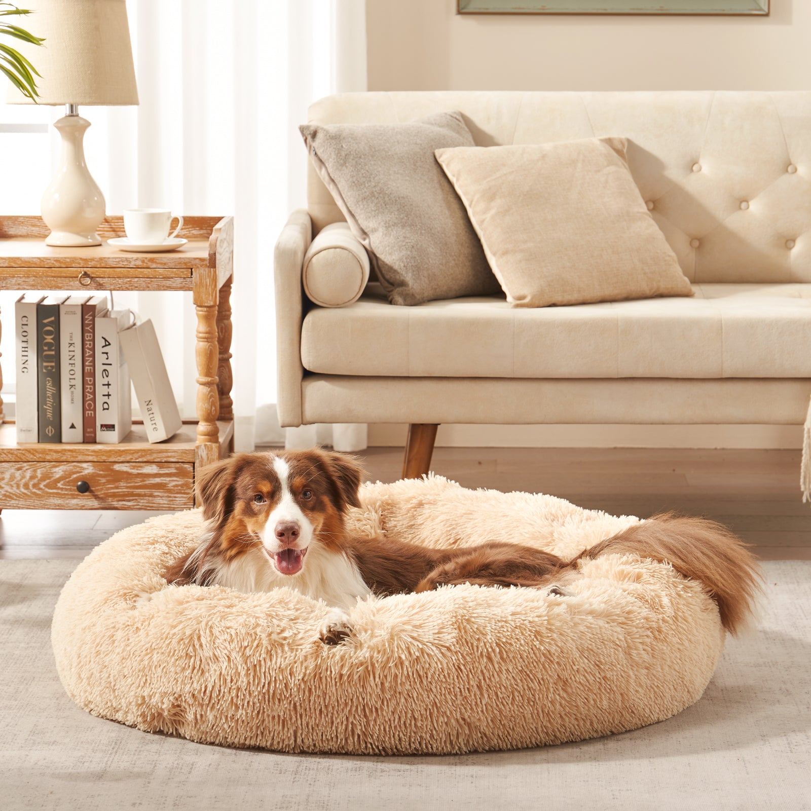 Dog resting in Inspaws calming donut dog bed in beige plush faux fur
