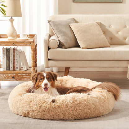 Dog resting in Inspaws calming donut dog bed in beige plush faux fur