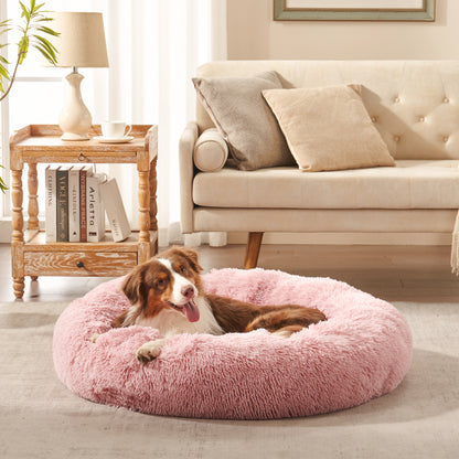 Dog resting in Inspaws calming donut dog bed in blush pink plush faux fur