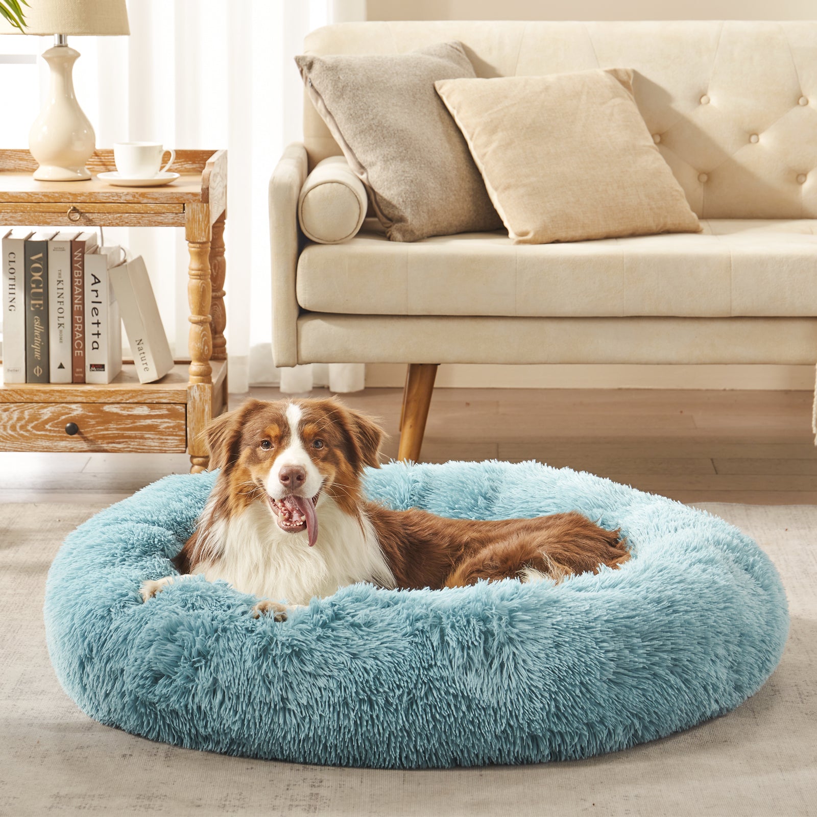 Dog resting in Inspaws calming donut dog bed in mint green plush faux fur