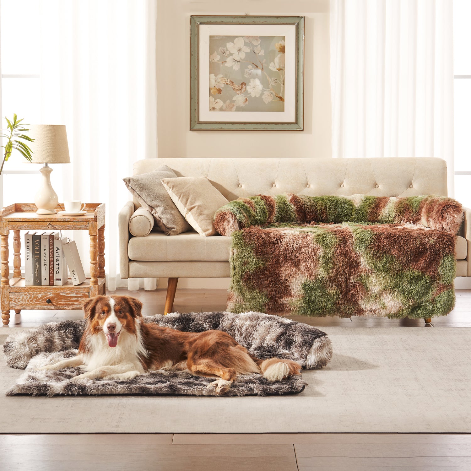 Dog resting on Inspaws faux long fur couch cover in ink tie-dye with green camo sofa protector on couch in living room