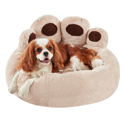 Cavalier King Charles Spaniel resting in Inspaws beige velvet calming paw dog bed flat view on white background
